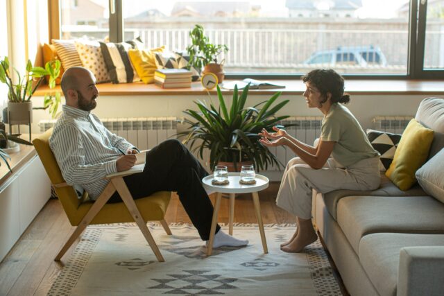 man and woman talking at therapy