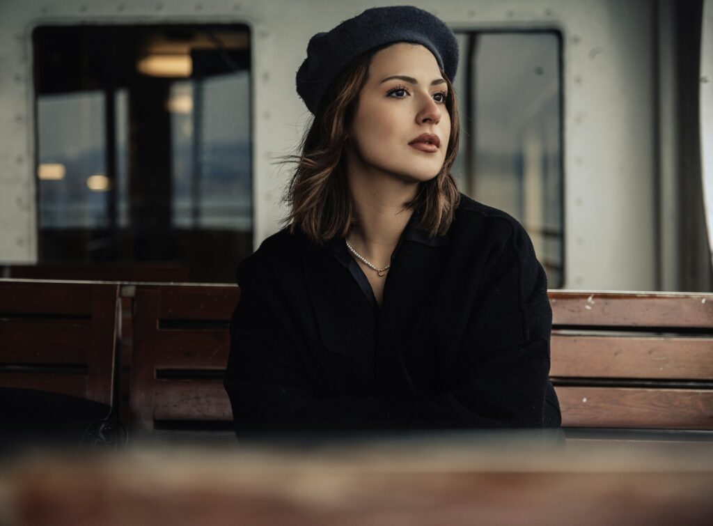 woman in beanie looking to side