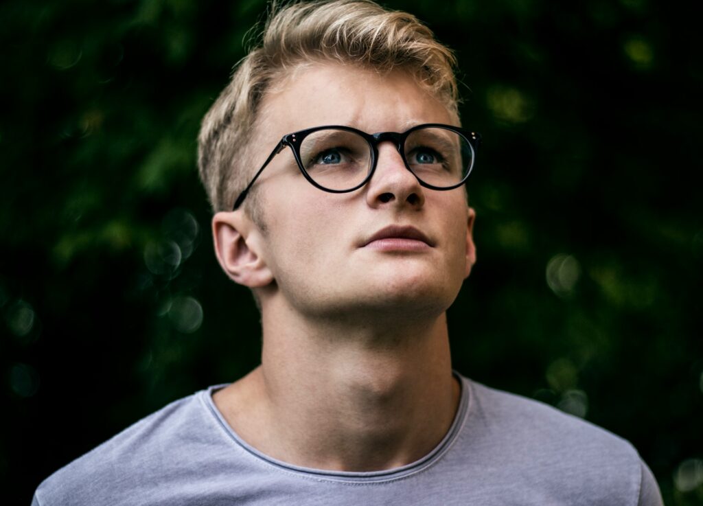 serious guy in glasses looking up