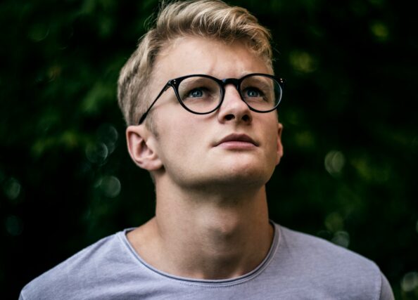 serious guy in glasses looking up