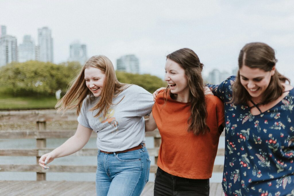 three female friends laughing and walking