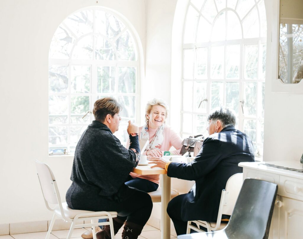 three female friends chatting at table