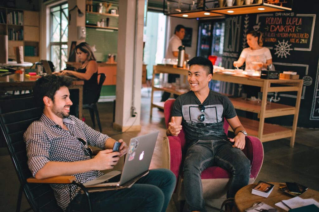 two male friends talking in coffee shop