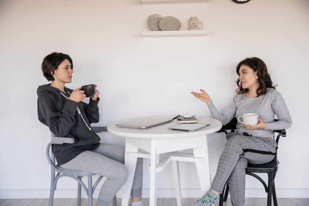 two friends chatting at table