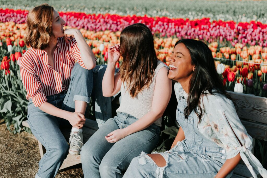 friends laughing in field of tulips