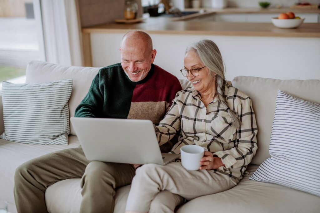 old couple on laptop on couch